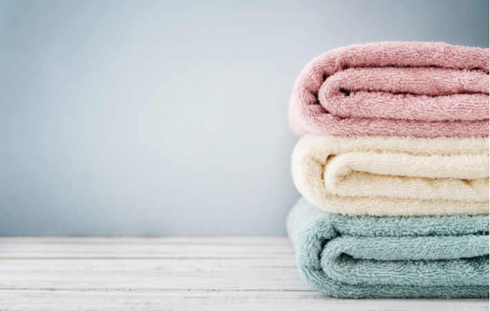 a stack of pink, yellow, and green folded towels