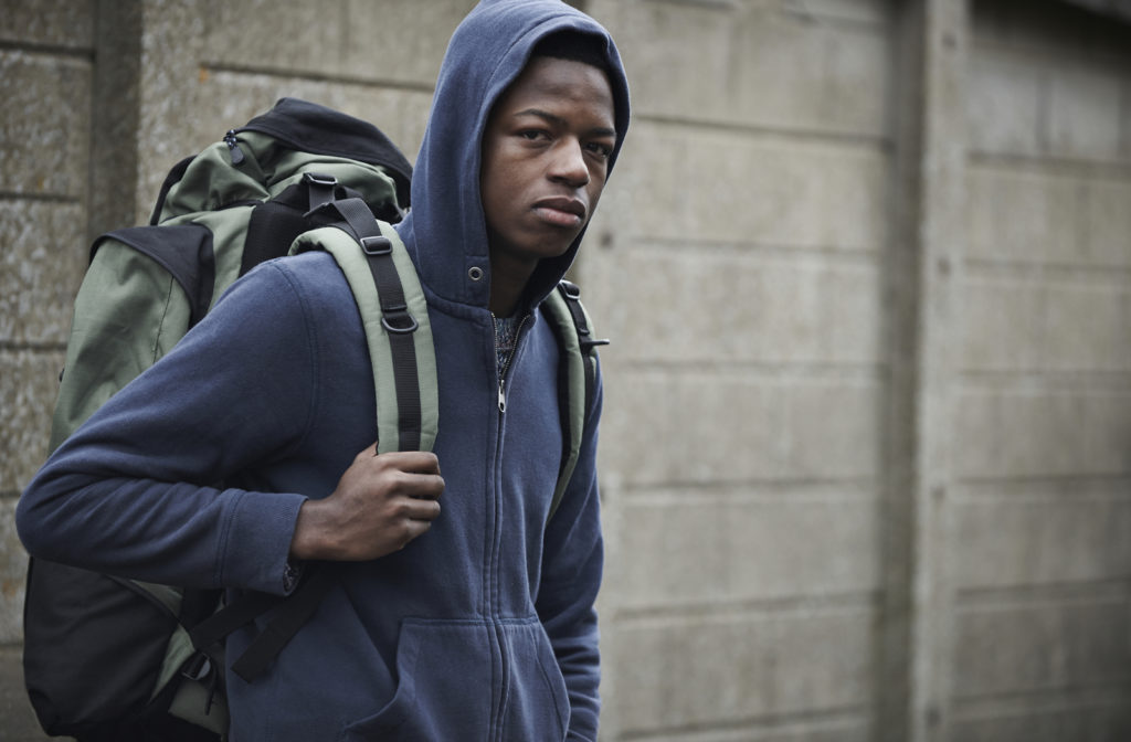 Young man experiencing homelessness while staying in the streets of Toronto.