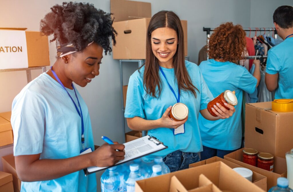 A group of nonprofit workers sort through food bank donations.