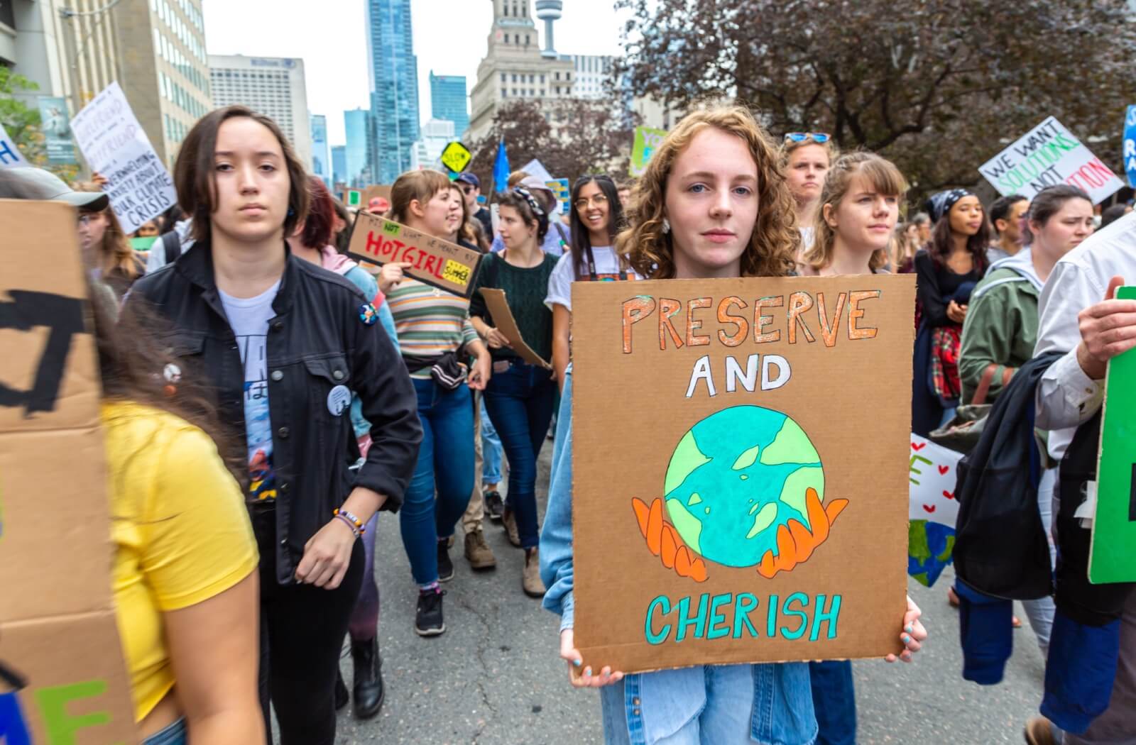 A young person holding a poster that reads "Preserve and Cherish" during the Global Strike for Climate and march for climate justice in Toronto, Ontario, Canada.